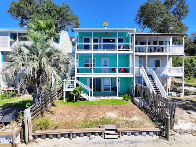 back of house with fence and a balcony