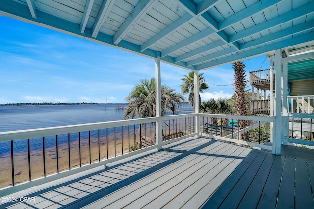 wooden terrace featuring a water view