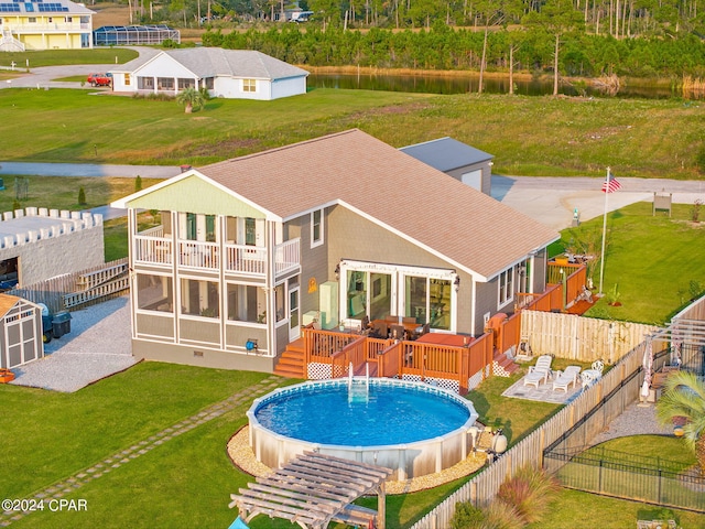 view of pool featuring a patio area, a wooden deck, and a lawn