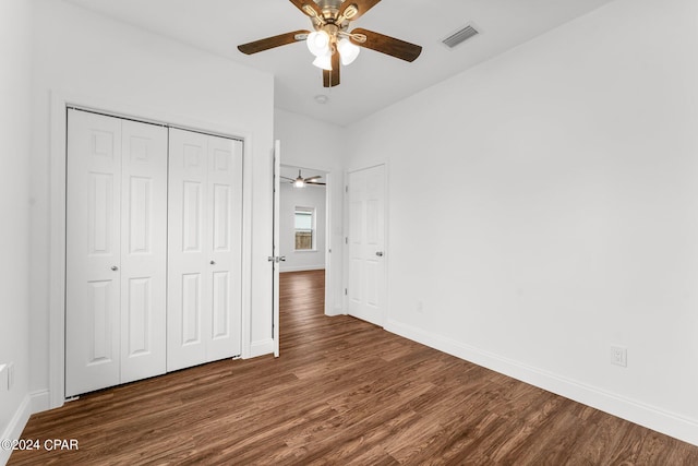 unfurnished bedroom with a closet, ceiling fan, and dark hardwood / wood-style floors