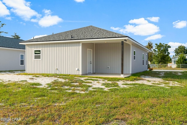 back of house featuring a yard and a patio