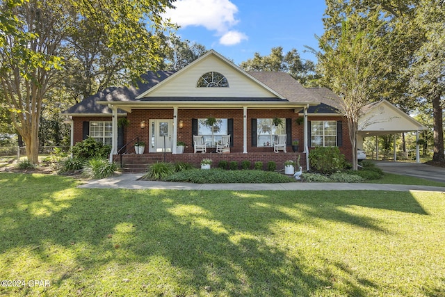 view of front facade with a carport, covered porch, and a front yard