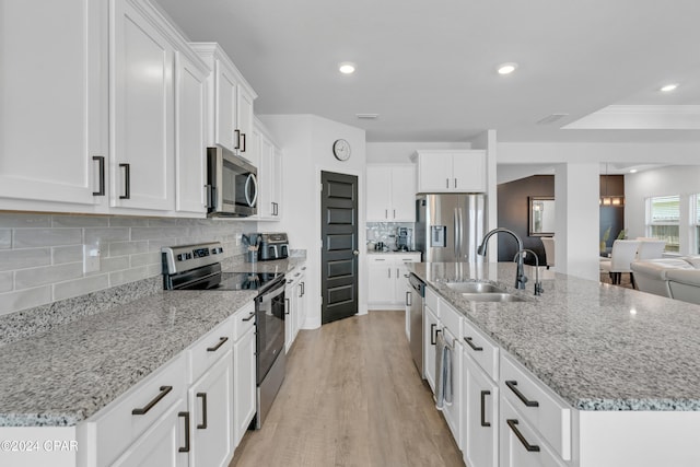 kitchen featuring a center island with sink, sink, and appliances with stainless steel finishes