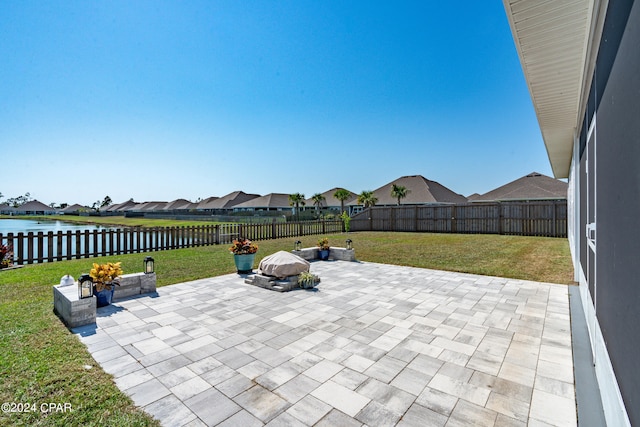 view of patio / terrace with a water view and a fire pit