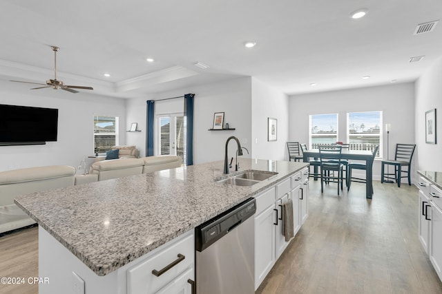 kitchen featuring dishwasher, white cabinetry, sink, and an island with sink