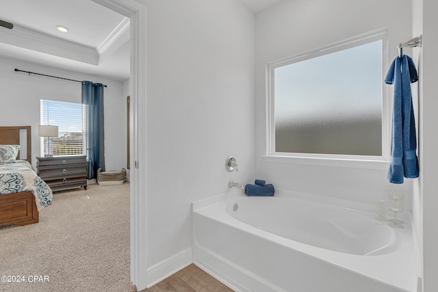 bathroom featuring a washtub and crown molding