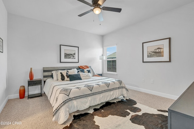 bedroom with ceiling fan and light carpet