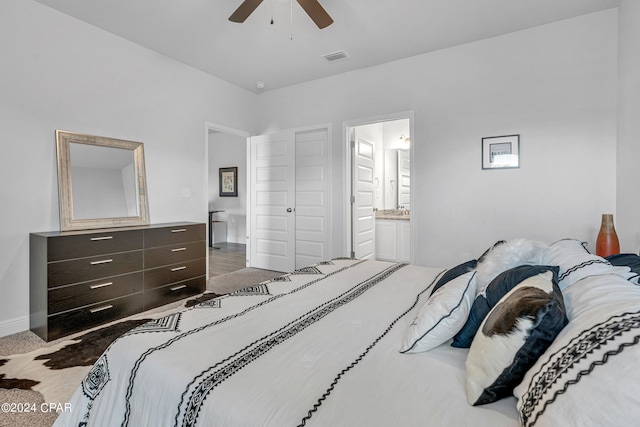 carpeted bedroom with ceiling fan and ensuite bath