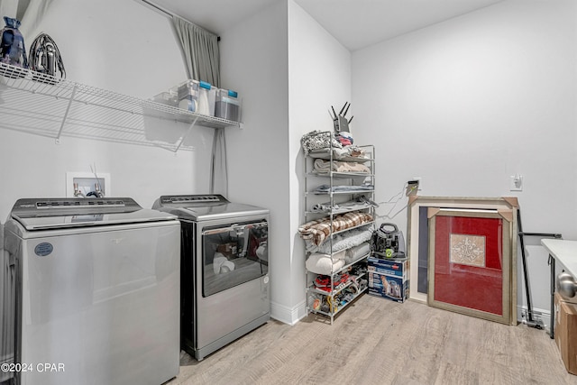 laundry room with light hardwood / wood-style floors and independent washer and dryer