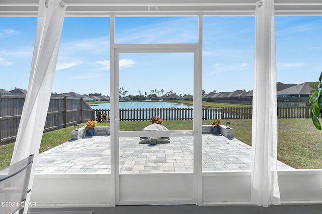 sunroom with a water view and a healthy amount of sunlight