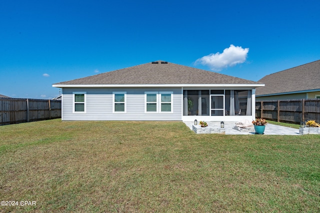 back of house with a lawn and a sunroom