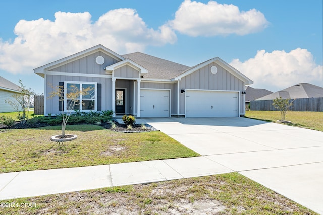 view of front of property featuring a garage and a front lawn