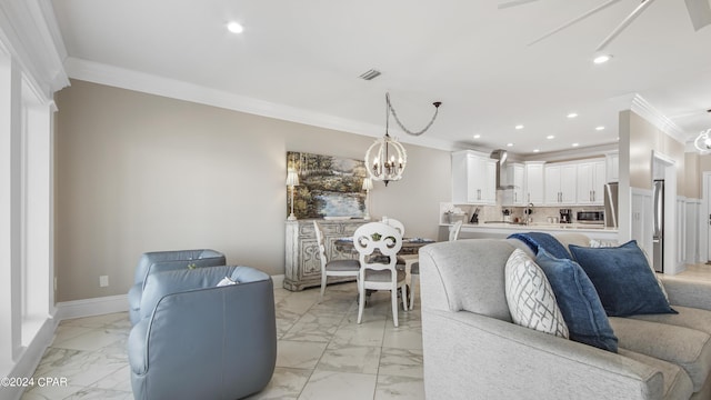 living room featuring an inviting chandelier and crown molding