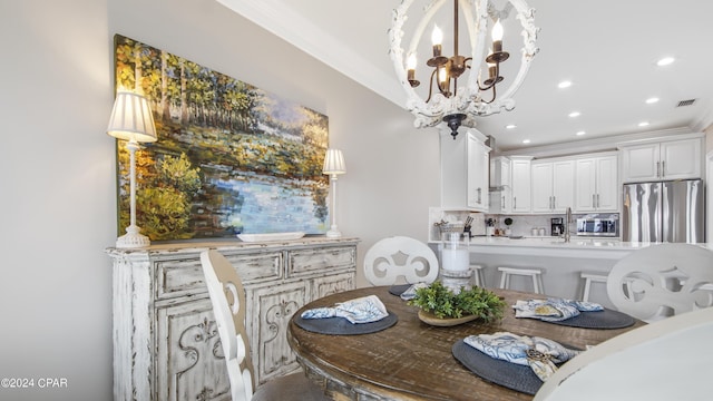 dining room featuring crown molding and a chandelier