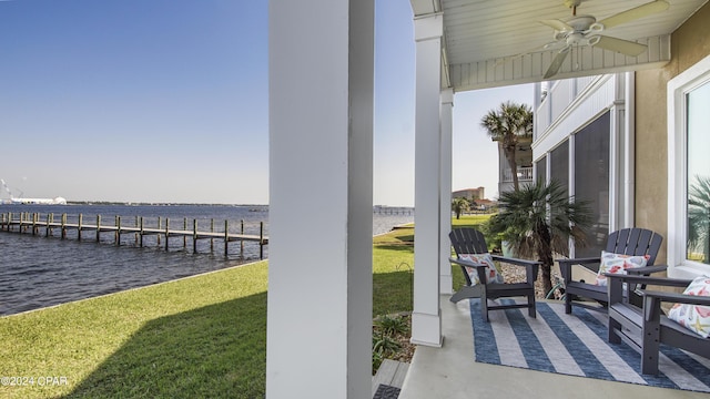 dock area with a water view and a lawn