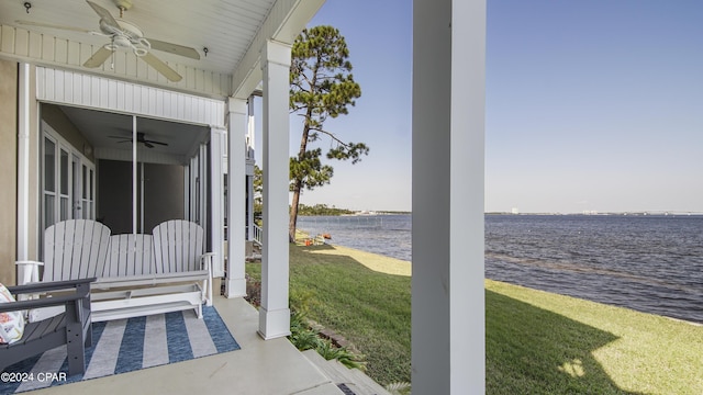 view of patio with covered porch, a water view, and ceiling fan