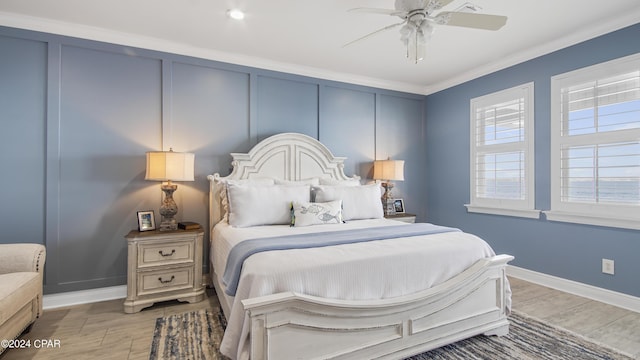 bedroom with ceiling fan and crown molding