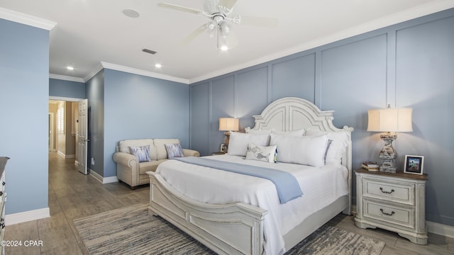 bedroom with ceiling fan, hardwood / wood-style floors, and ornamental molding