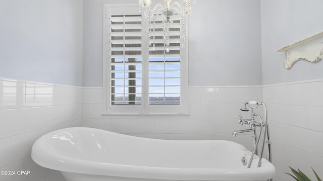 bathroom featuring a tub and tile walls