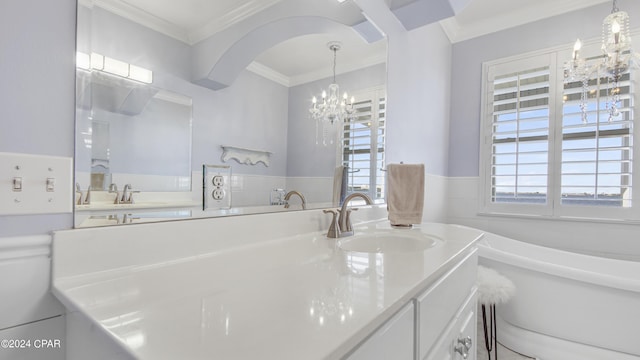 bathroom featuring vanity, crown molding, a tub to relax in, and a chandelier