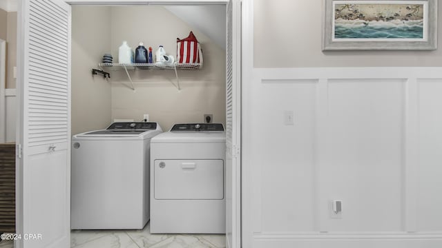 clothes washing area featuring independent washer and dryer