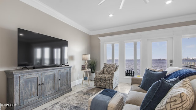 living room with crown molding, ceiling fan, and a healthy amount of sunlight