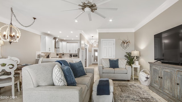 living room featuring ceiling fan with notable chandelier and crown molding