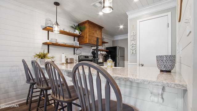 kitchen with stainless steel appliances, light stone countertops, dark hardwood / wood-style flooring, and decorative light fixtures