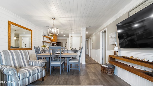 dining area featuring ornamental molding, dark hardwood / wood-style floors, a chandelier, and wooden ceiling