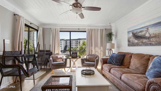 living room featuring ornamental molding, wood ceiling, light wood-type flooring, and ceiling fan