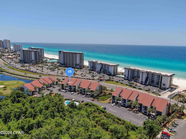 birds eye view of property featuring a water view and a beach view