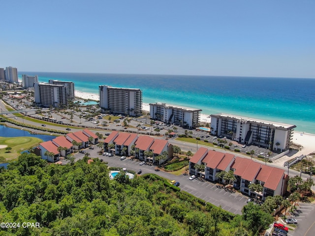 birds eye view of property with a water view and a view of the beach