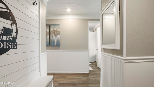 corridor with ornamental molding and dark hardwood / wood-style floors