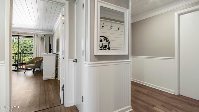 corridor with crown molding, wooden ceiling, and dark wood-type flooring