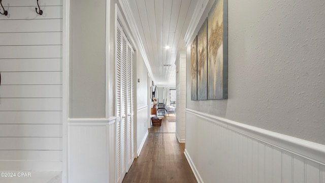 corridor with ornamental molding and wood-type flooring