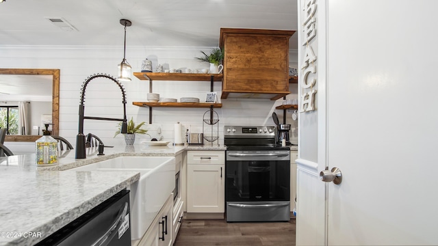 kitchen featuring appliances with stainless steel finishes, light stone counters, decorative light fixtures, and white cabinetry