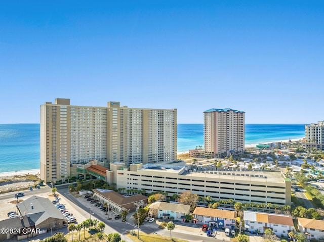 drone / aerial view with a water view and a beach view