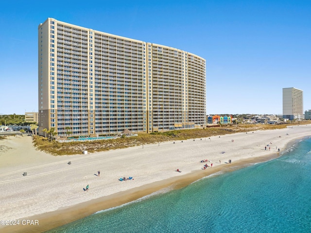 view of building exterior with a view of the beach and a water view