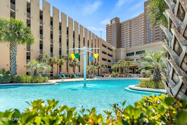 view of swimming pool with pool water feature