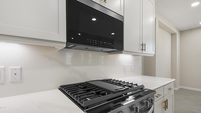 kitchen featuring white cabinets, stainless steel appliances, and light hardwood / wood-style floors