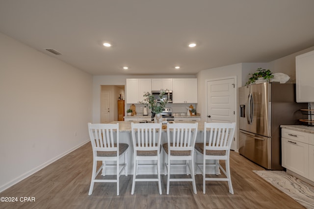 dining space featuring light hardwood / wood-style floors