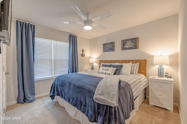 bedroom with ceiling fan and light carpet