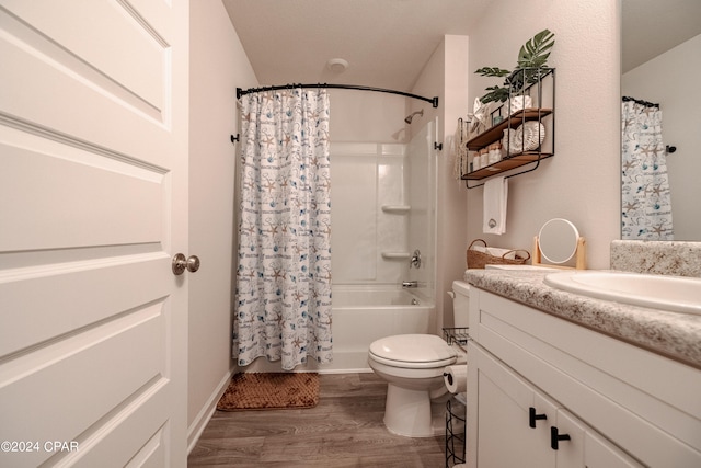 full bathroom featuring toilet, hardwood / wood-style flooring, vanity, and shower / tub combo