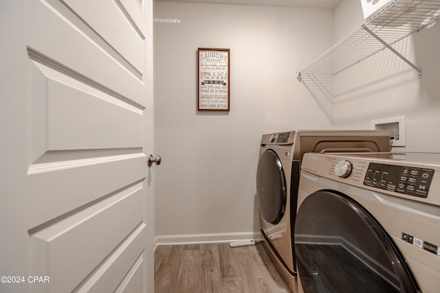 washroom with light hardwood / wood-style floors and washer and clothes dryer