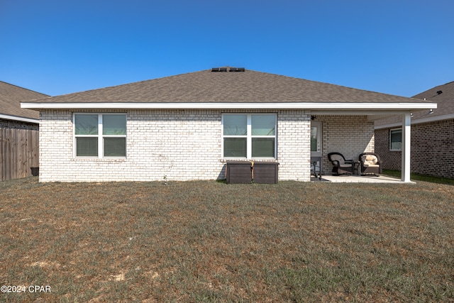 back of house featuring a patio area and a yard