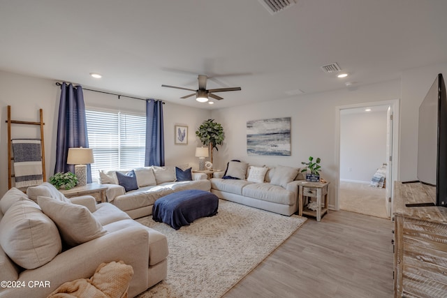 living room featuring light wood-type flooring and ceiling fan