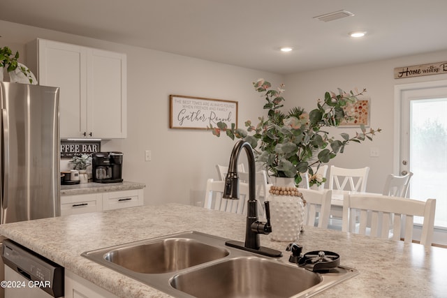 kitchen with sink, appliances with stainless steel finishes, and white cabinets