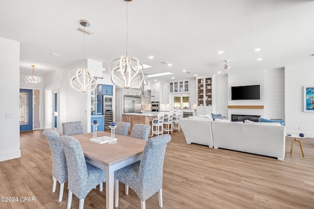 443 Wahoo Rd, Panama City Beach, FL 32408 - dining room featuring a chandelier, recessed lighting, beverage cooler, baseboards, and light wood finished floors