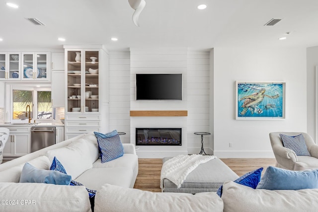 443 Wahoo Rd, Panama City Beach, FL 32408 - living room featuring baseboards, light wood finished floors, recessed lighting, and a fireplace