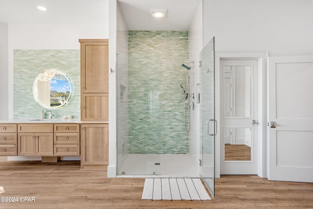 bathroom with vanity, hardwood / wood-style flooring, and walk in shower